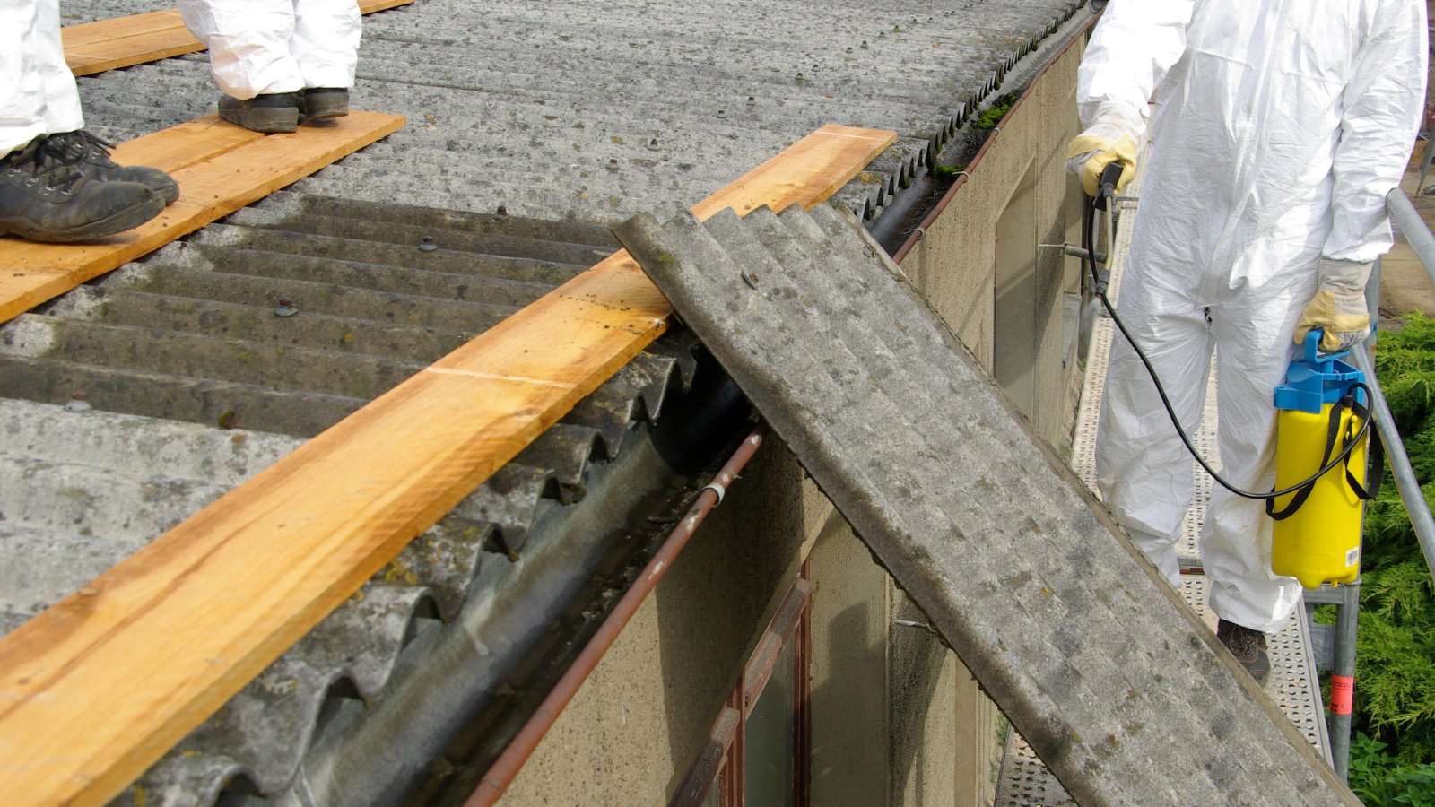 Asbestos roofing materials being removed
