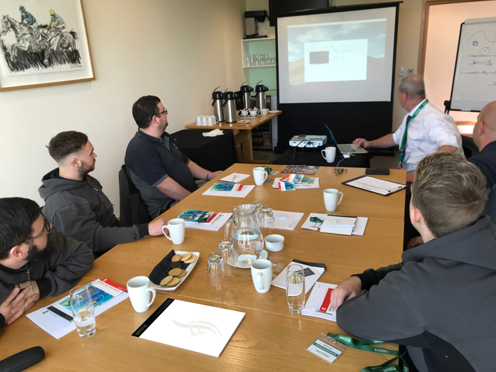 Group of construction workers watching a presentation in the classroom at an RJS Waste Management asbestos awareness training course