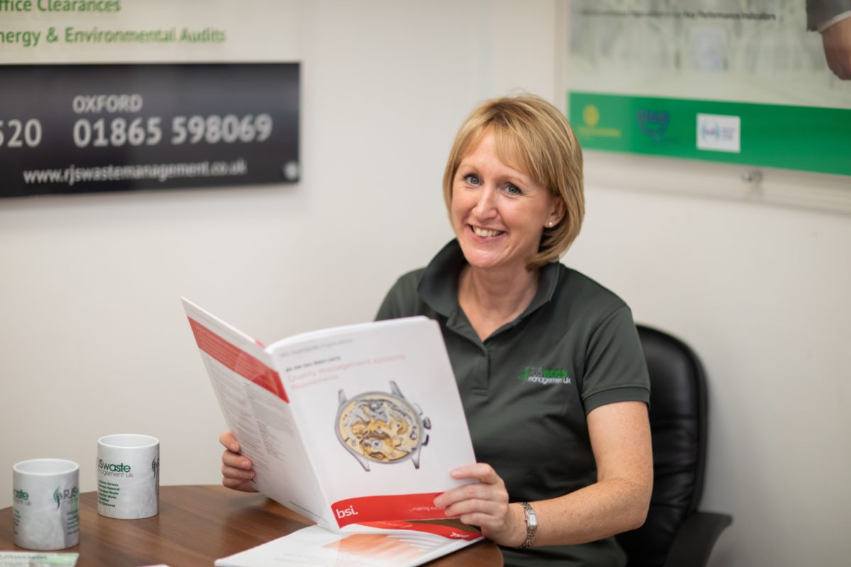 Business and Compliance Manger Samantha James reading a health and safety brochure