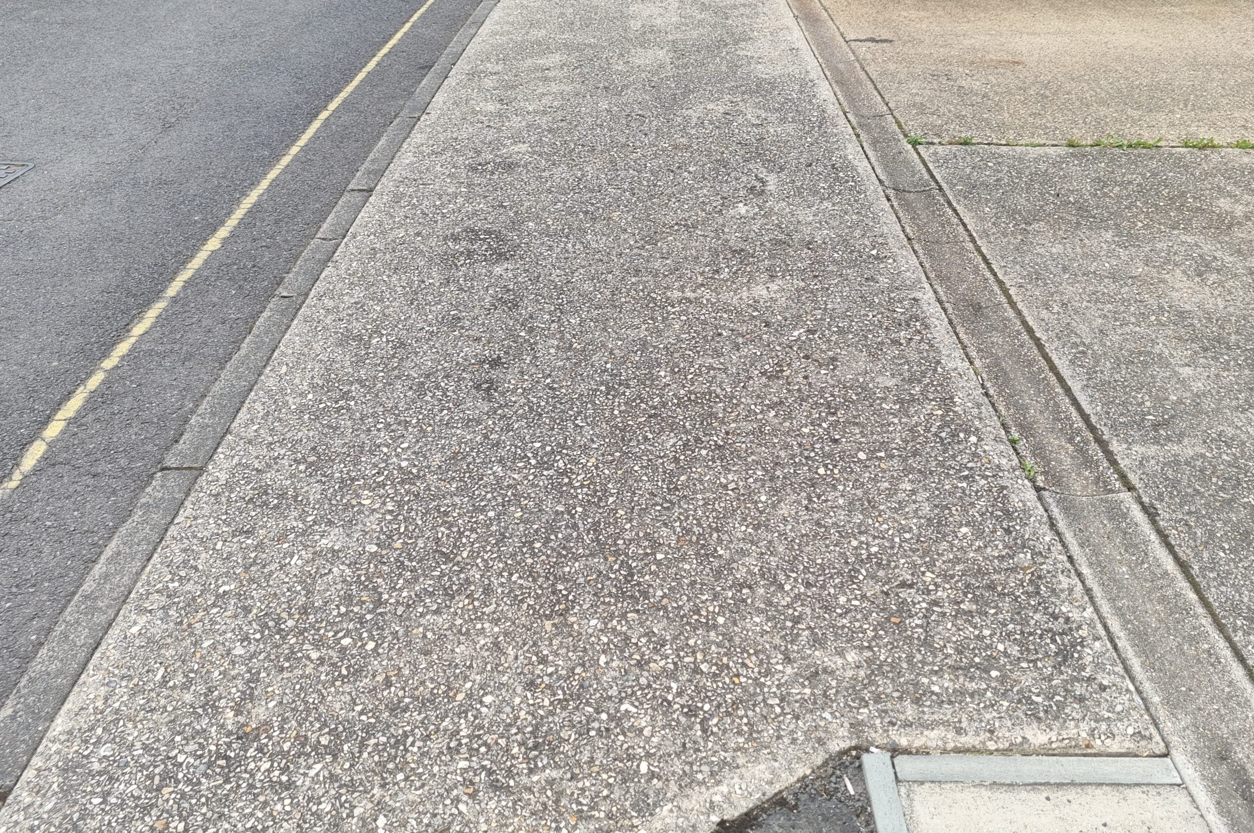 Before driveway cleaning – Where RJS Waste Management's driveway connects to the road