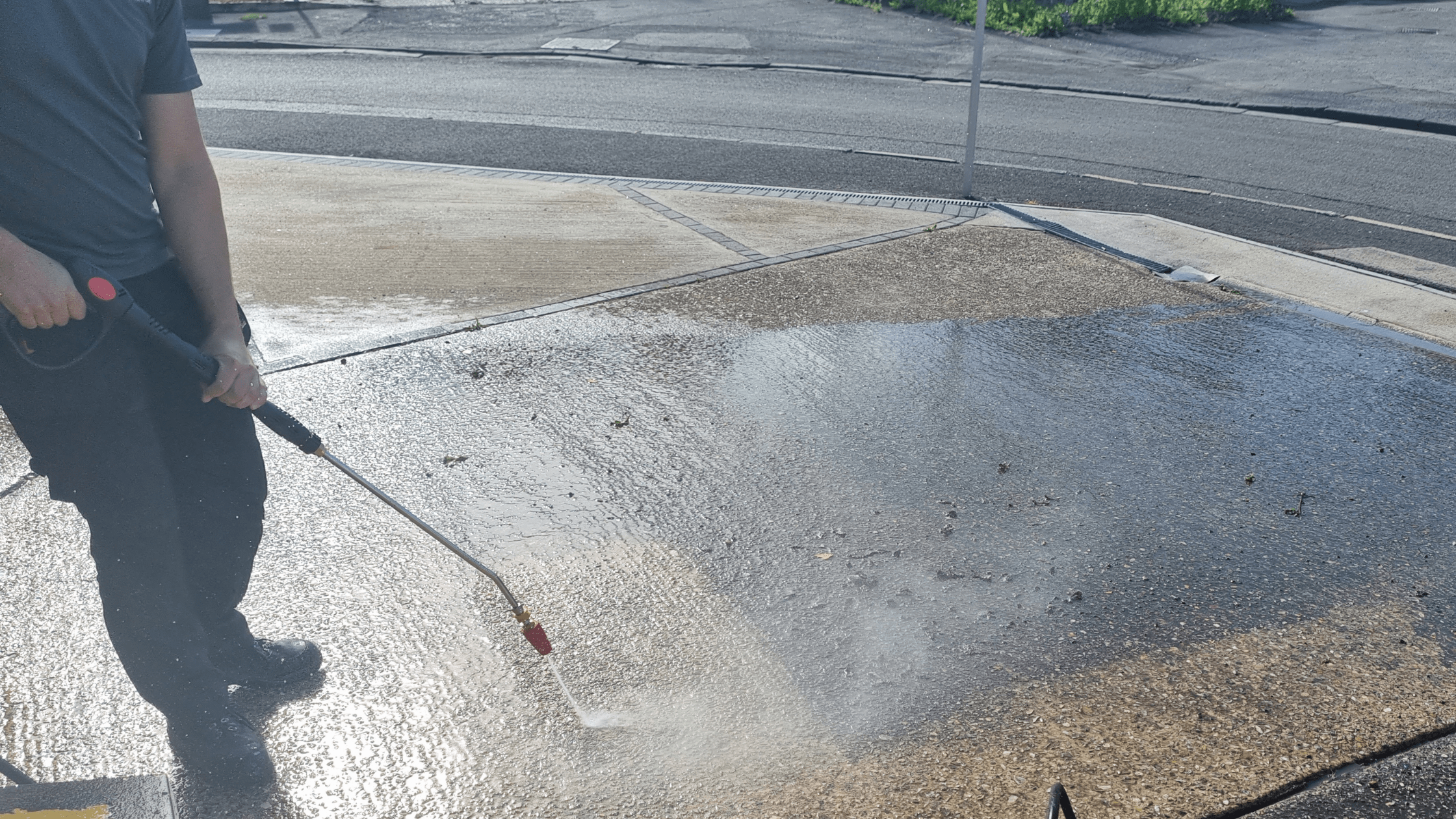 RJS Waste Management worker cleaning a driveway with a V-Tuf 110v pressure washer