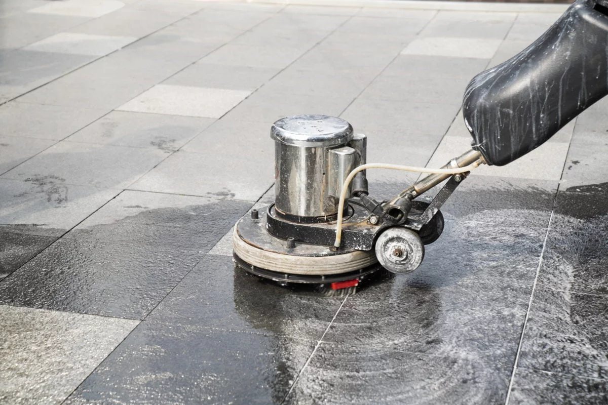 Commercial cleaning using polishing machine on paving