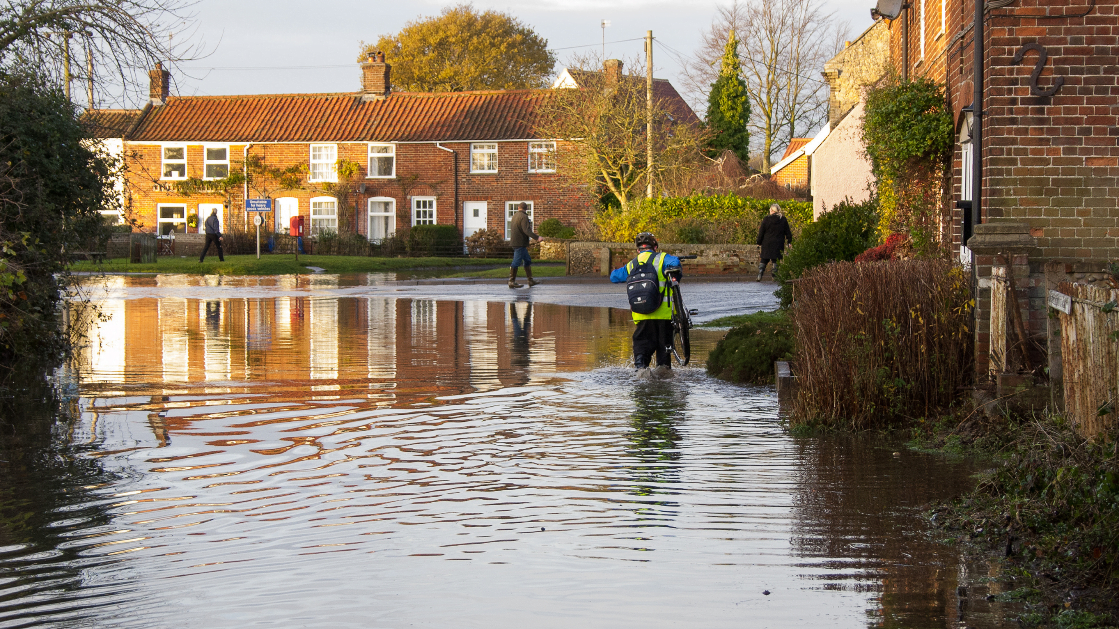 Flood awareness - People and houses in flooded Suffolk residential area