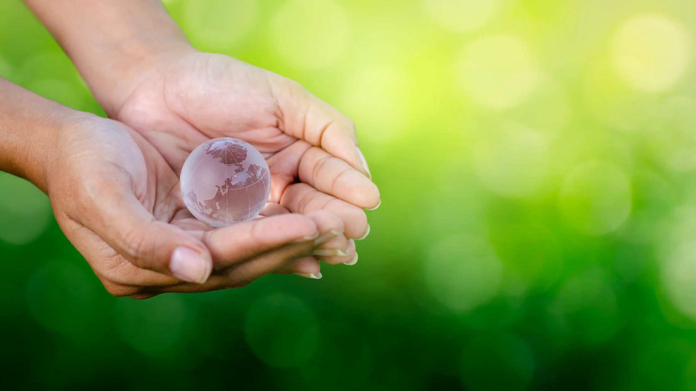 Woman holding the world in her hands to represent saving the planet