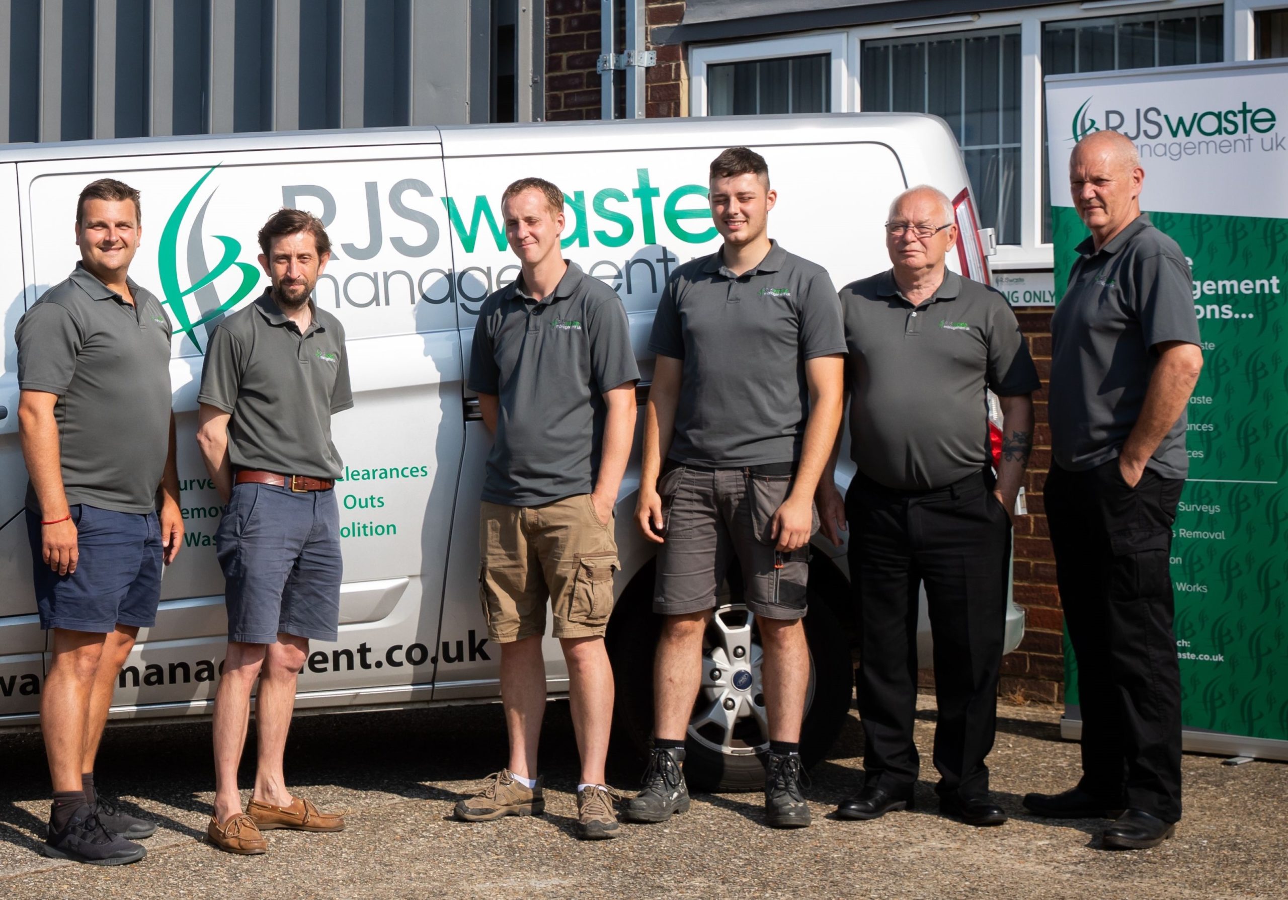 RJS Waste Management team standing in front of company van