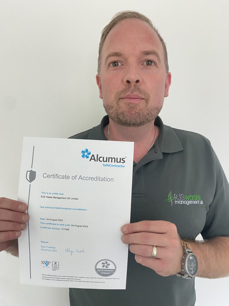 RJS Waste Management's Tony Wells holding the company's SafeContractor certificate