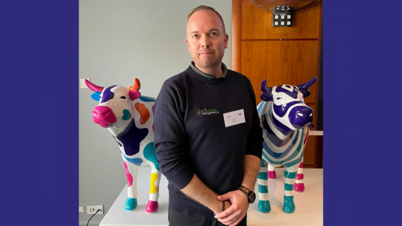 RJS Waste Management's Tony Wells standing in front of OxTrail sculptures.