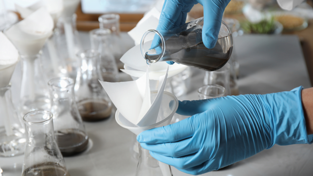 Lab technician performing contaminated soil sample for WAC test